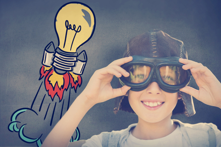 Portrait image of boy with flying goggles against grey roomの写真素材