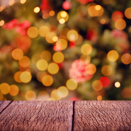 Wooden floor  against desk with christmas tree in background