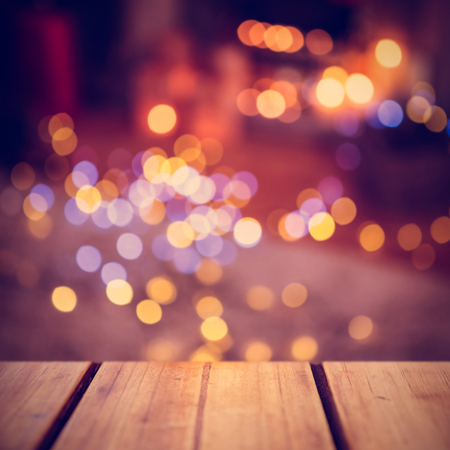 Focus of wooden shelf against defocused of christmas tree lights and fireplaceの写真素材