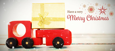 Christmas card against toy tempo carrying christmas present against white background