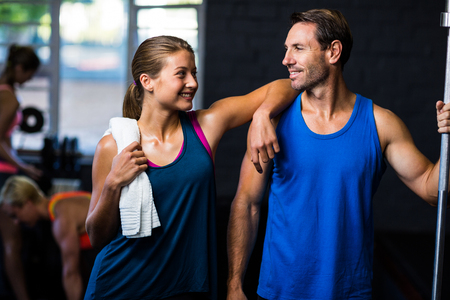 Smiling friends standing in gymの写真素材