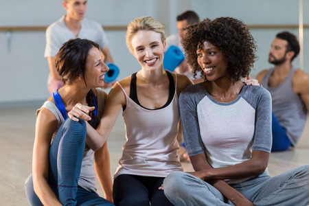 Women sitting on floor in fitness studioの写真素材