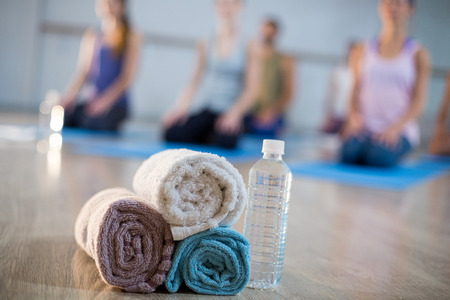 Close-up of towel and water bottle in gymの写真素材