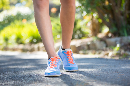 Woman's feet jogging in parkの写真素材