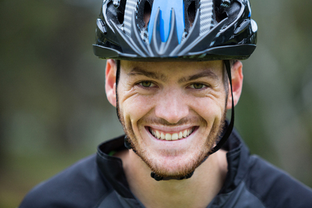 Portrait of smiling male athletic in parkの写真素材