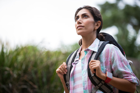Thoughtful hiker standing at countryside in forestの写真素材