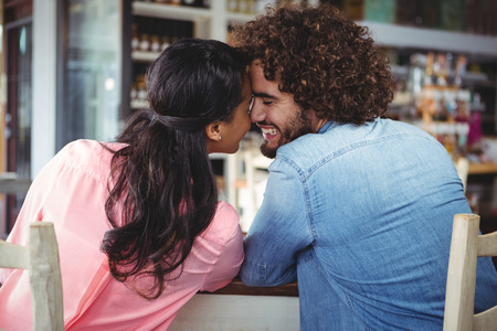 Happy couple romancing in cafeteriaの写真素材
