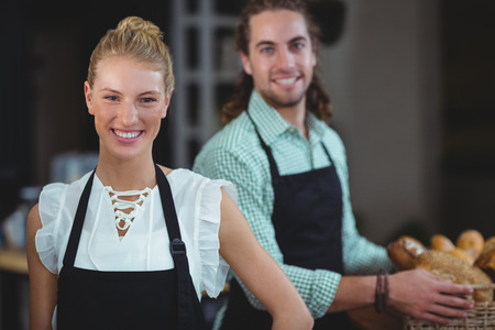 Portrait of waiter and waitress working behind the counter in cafeの写真素材