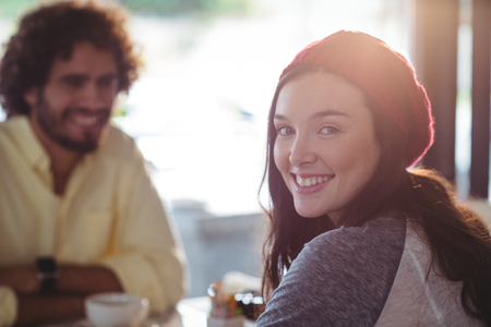 Portrait of smiling woman having cup of coffee in cafeの写真素材