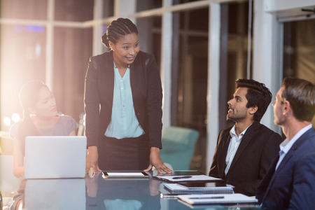 Businesswoman interacting with coworkers in a meeting in the conference roomの写真素材