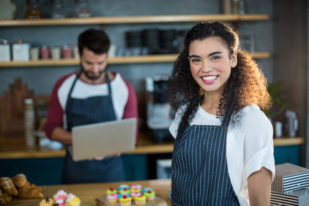 Portrait of smiling waitress in cafÃ©の写真素材