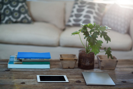 Digital tablet and laptop on a table at homeの写真素材
