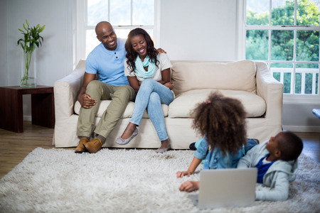Children interacting with parents at homeの写真素材