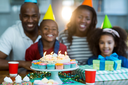 Portrait of family with birthday cake at homeの写真素材