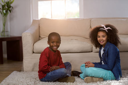 Portrait of children smiling at homeの写真素材