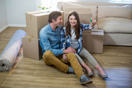Happy couple holding the key of new home