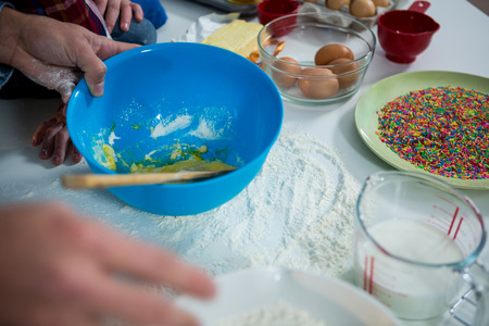 Close-up of man preparing cupcake in the kitchen at homeの写真素材