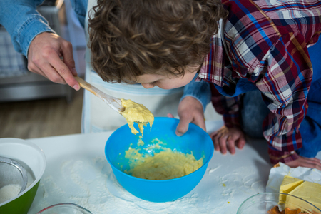 Father and son preparing cupcake in the kitchenの写真素材