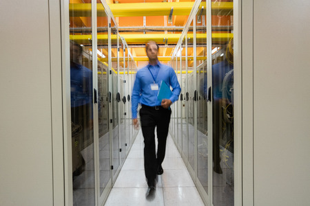 Technician walking in hallway of server room