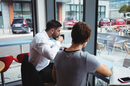 Businesspeople having a cup of coffee in officeの写真素材