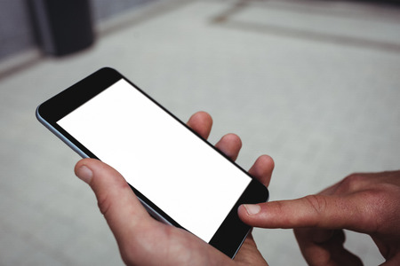 Businessman using mobile phone in office building