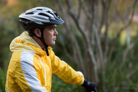 Male biker with bicycle helmet in countrysideの写真素材