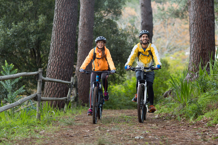Biker couple cycling in countryside forestの写真素材