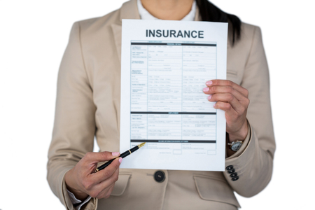 Mid section of businesswoman showing insurance contract against white backgroundの写真素材