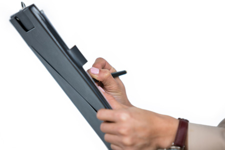Businesswoman filling insurance contract form in office