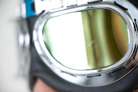 Close-up of man wearing aviator goggles against white backgroundの写真素材