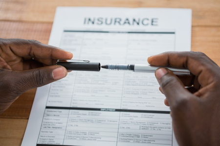 Close-up of businessman putting cap on penの写真素材