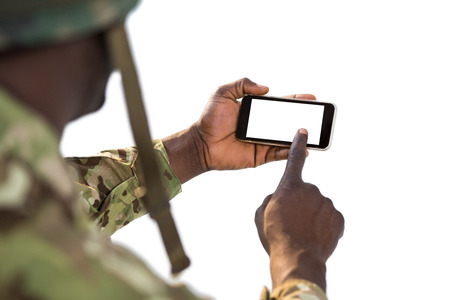 Soldier using a mobile phone against white background