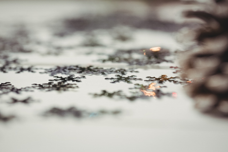 Pine cone and snowflake on wooden table during christmas timeの写真素材