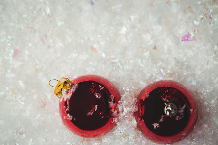Close-up of christmas baubles on snow during christmas timeの写真素材