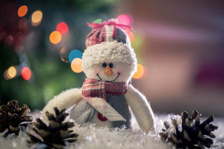 Snowman and pine cone on snow during christmas timeの写真素材