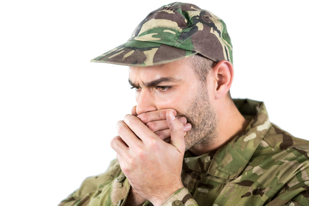 Soldier covering his mouth against white backgroundの写真素材