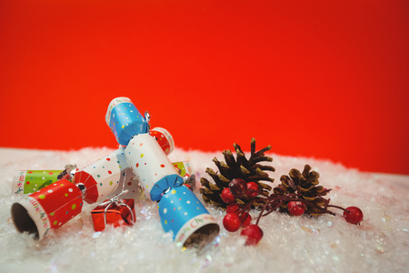 Christmas crackers and christmas decoration on snow during christmas timeの写真素材