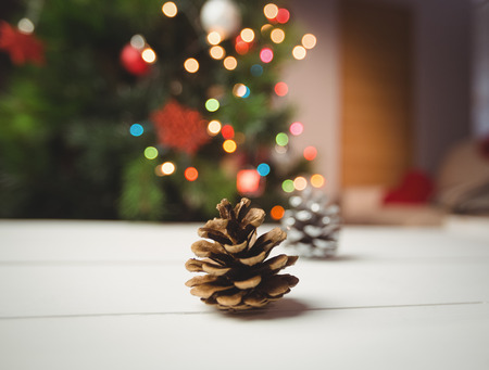 Close-up of pine cone on wooden table during christmas timeの写真素材