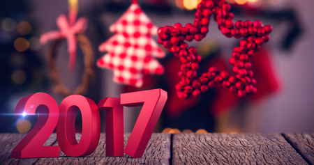 Composite image of number in red against christmas ornaments hanging on ribbonの写真素材