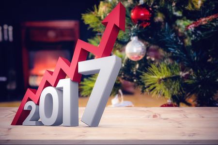 Digital composite of numbers with arrow against wrapped gifts near a christmas treeの写真素材