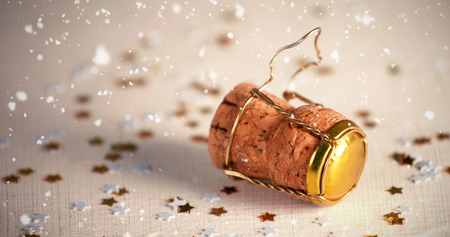 Snow falling against wooden champagne cork with confettiの写真素材