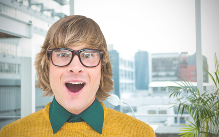 Portrait of surprised hipster businessman  against working desk in a officeの写真素材