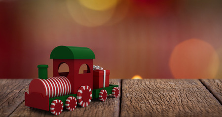 Train set with gift against close-up of candles burningの写真素材