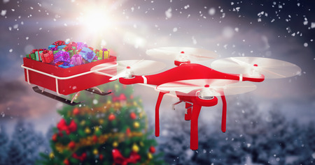 High angle view of flying drone pulling Chirstmas sledge against christmas tree in snowy forestの写真素材