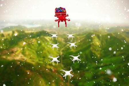 High angle view of mini drone pulling Chirstmas sledge with gift against view of beautiful landscapeの写真素材