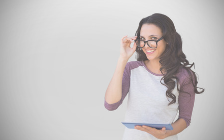 Brunette with tablet pc against white background with vignetteの写真素材