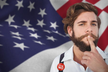 Portrait of hipster with finger on chin against close up of the us flagの写真素材