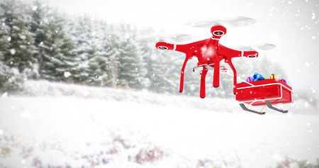 Drone pulling sledge against snow covered trees against skyの写真素材