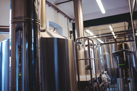 Industrial equipment at illuminated breweryの写真素材