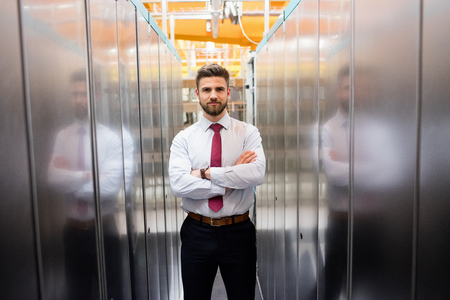 Portrait of technician standing with arms crossed in a server room